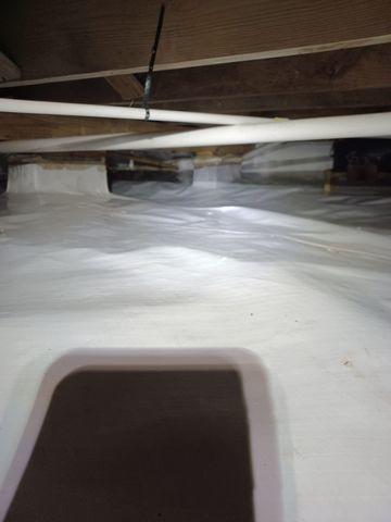 The various materials used when encapsulating this crawlspace are ideal for capturing water and sending it to a sump pump, which removes the water and sends it outside.