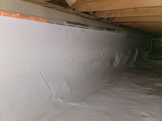 Here is what the crawl space wall will look like after encapsulation. The vapor barrier is sealed to the wall for moisture, air, and thermal boundary protection.