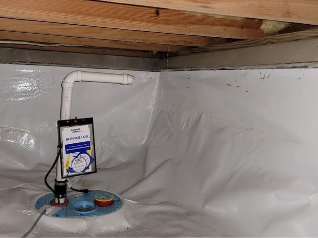 Here is an installed sump pump in the crawl space.