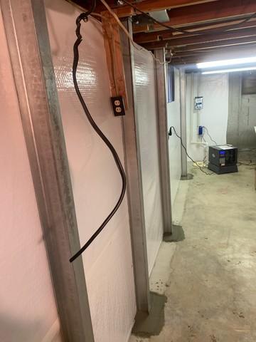 After CleanSpace is installed, we install PowerBraces over it. PowerBraces are the floor to ceiling anchors that prevent any more inward movement. Overtime, PowerBraces can be torqued to help straighten the wall.