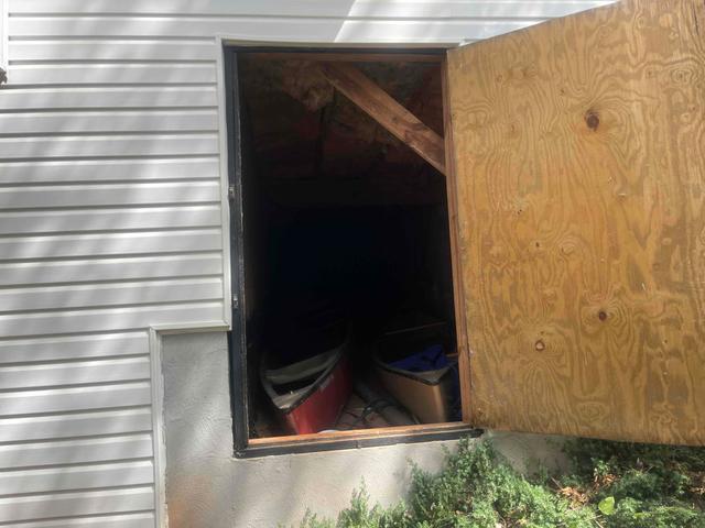 The crawl space door was made of wood and not sealed to keep out moisture.