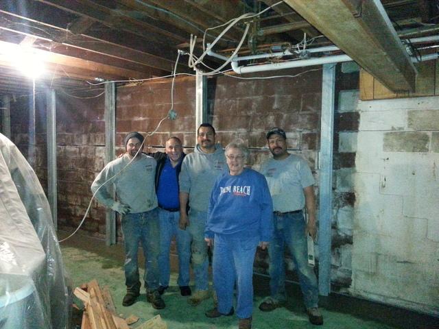 Here you can see our crew with the homeowner, the homeowner is clearly happy that her basement is now structurally sound and uncompromised.