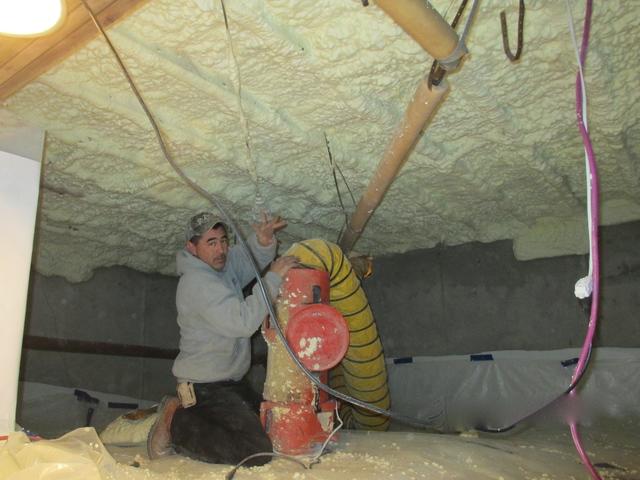 Here you can see one of our crawl space specialists Lupio cleaning up after the foam has been sprayed