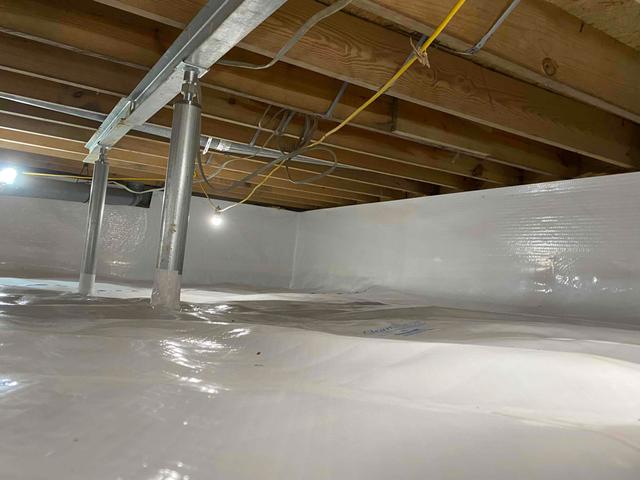 SmartJack support posts were installed to stabilize the crawl space floor joists and relevel the floors above