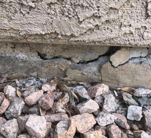 Symptoms of Foundation Problems in a Concrete Stem Wall: Spalling Concrete