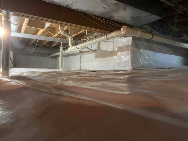 We encapsulated the crawl space with CleanSpace vapor barrier to prevent moisture from passing through the ground and SmartJack support posts to stabilize the floors above