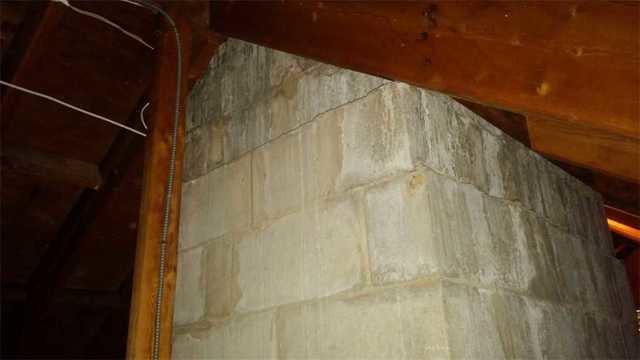 For safety, it is important that a masonry chimney not be touching combustible materials such as wood, fiberglass insulation, or foam.  The answer is to wrap the chimney with Rockwool, a non-combustible fireproof mineral fiber.  Then, for added R-value, SilverGlo foam insulation can be installed and sealed against the Rockwool.