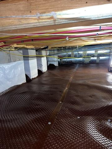 The failing cheap vapor barrier system was removed and the first step of the CleanSpace Encapsulation System was installed - drainage matting. This layer installed over the ground in the crawl space allows water that seeps in under the vapor barrier to drain properly.