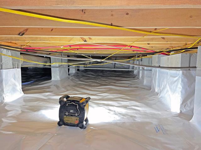 Above the drainage matting layer, a CleanSpace vapor barrier is installed. CleanSpace vapor barrier is a multi-layer vapor barrier that is reinforced to prevent tearing or being easily pulled down from the walls when crawled on. The material even has its own insulative value and heat resistance built in.