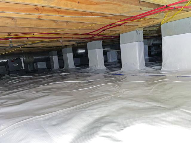 Visible on the back left is the second of 2 SaniDry Sedona dehumidifiers installed in this crawl space to effectively control the moisture level in the crawl space.