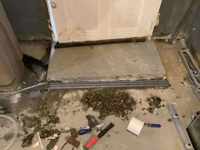 We also installed a TrenchDrain right at the entrance of the basement door. These kinds of entrances have gaps that allow water to pass through easily, so collecting the water here will help waterproof this basement.