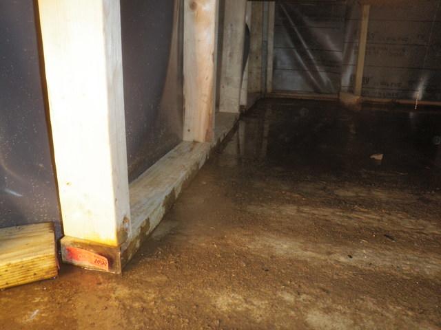 The crawl space after the water is drained