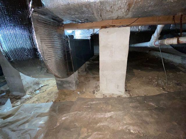 Exposed dirt floors and more dirty plastic.  The HVAC ducts travelling through the crawl space were subject to whatever uncontrolled temperatures existed.