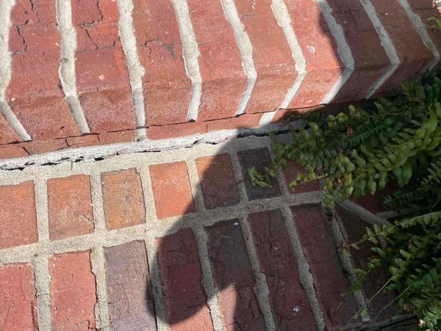 Front steps cracked and separating from the front porch