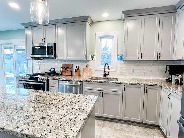 A new kitchen sink was installed as well, a nice dark bronze color matches the subtle hints of color in the countertops.