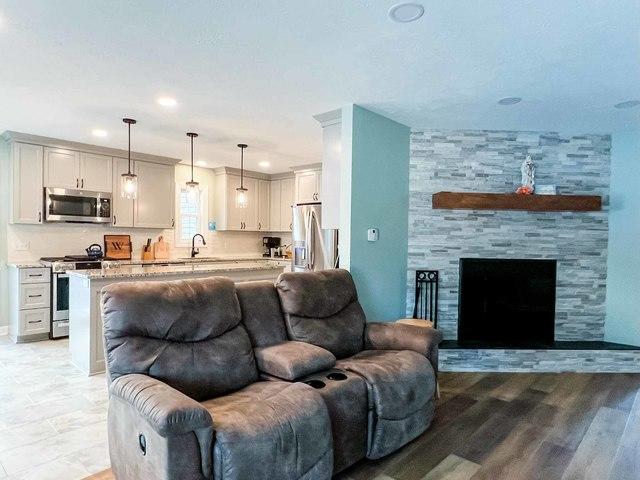 DBC also tiled this fireplace as well, tying nicely into the kitchen colors as well. Finished off nicely with a wood mantel.