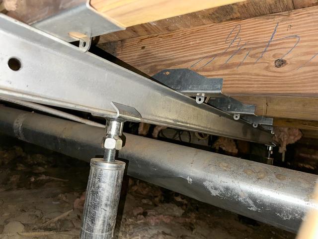 The SmartJack Support System was installed to provide additional support to the areas of the floor that were sagging and causing cracks in the drywall. This photo shows the SmartJacks in place and doing their job to help level the floor and provide support.