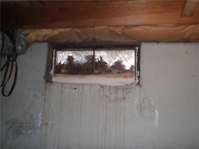 Old metal windows like this one in Berlin, CT can rust, allowing water to flow into the basement.