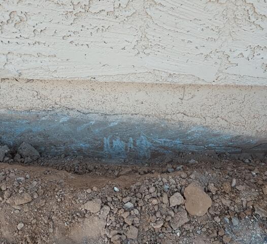 Symptoms of Corrosion in a Concrete Stem Wall: Flaking Paint