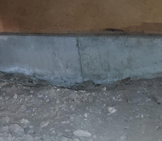 Symptoms of Corrosion in a Concrete Stem Wall: Vertical Concrete Cracks