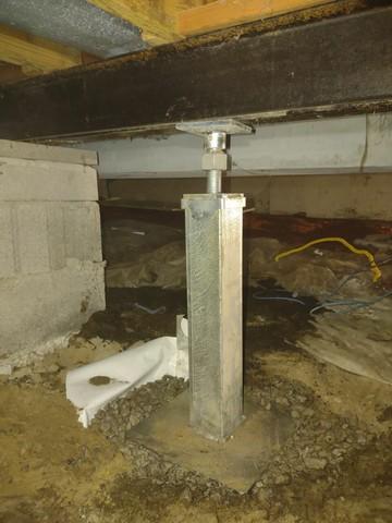 After the area was dug out, the installation crew poured the concrete and prepared for the rest of the system. SmartJacks utilize steel columns that attach to the floor joist and base for reinforcement. The team was able to level and permanently stabilize Donna's home!