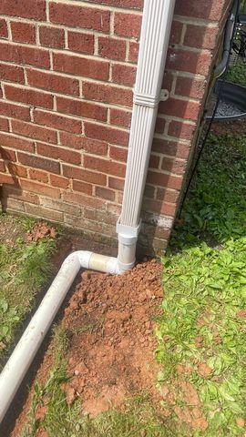 This down spout used to just dump water right at the foundation walls of this home.  Now it will be controlled and sent away into the yard.