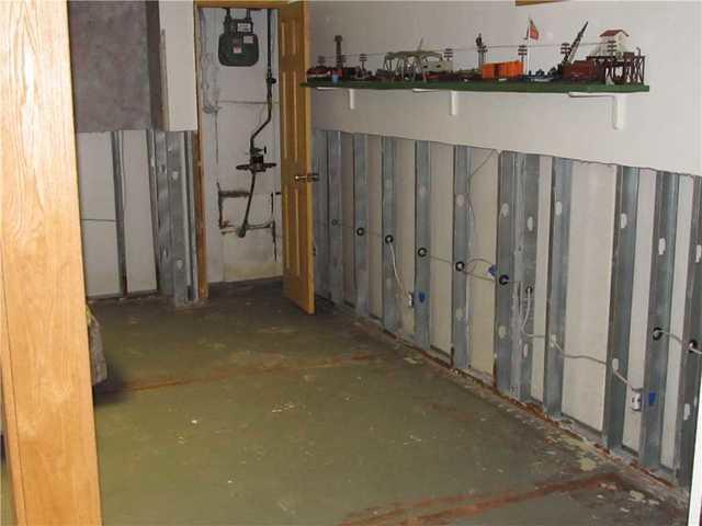 Because of the backup in the drainage pipes due to iron ochre, water leaked into this basement and ruined the drywall. 