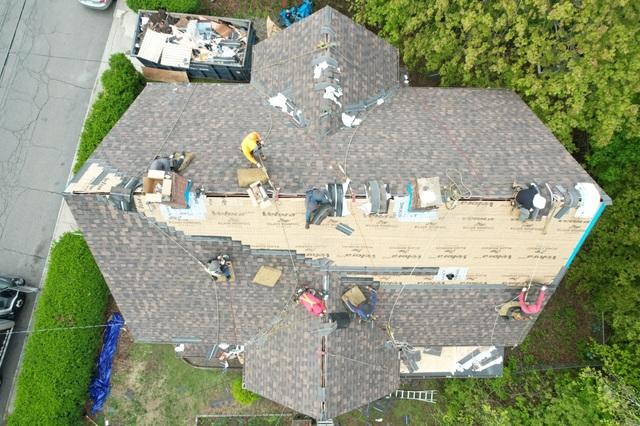 As we neared the end of the day our team is finishing up the last bits of the roof. Here you can see how we layer the shingles to ensure that water runs off the roof, we start at the bottom and layer our shingle one after the other all the way to the top.