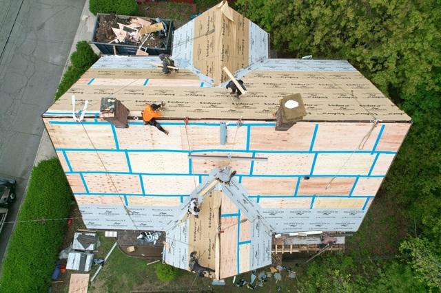 In this photo you can see the three different materials we use to seal the house off from the elements. First we tape off all the seams where the plywood sheets are put together. Next we use SealeronXT Ice and Water to seal all the edges, valleys and peaks. Next we lay Velora Underlayment over the whole roof as a final weather barrier.