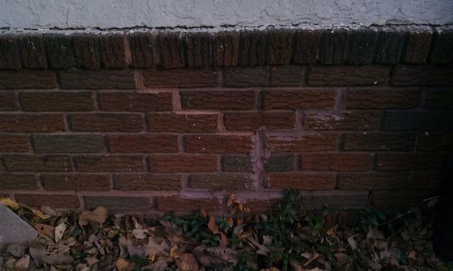 In this example the mortar was simply replaced or repaired.  The actual problem of the house settling was not repair at the time. You can see the house is still continuing to settle, and the cracks are starting to redevelop. New mortar is not enough to sustain the massive weight of a settling two story turn of the century home.