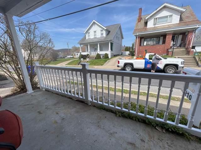 White 36" Superior T Vinyl Railing /Colonial Balusters / New England Caps / Post cemented in Ground in front of porch