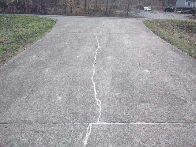 Cracked concrete driveway after repairs