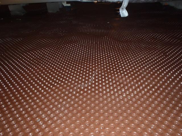 <p>The dimpled drainage matting is installed over the dirt floor. This creates air space for water to flow that has leaked into the crawl space.  </p>