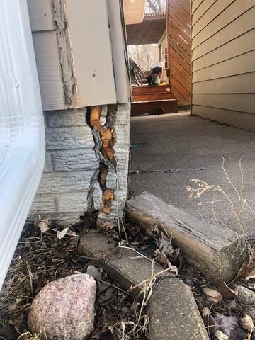 Look at how badly street creep damaged this garage.