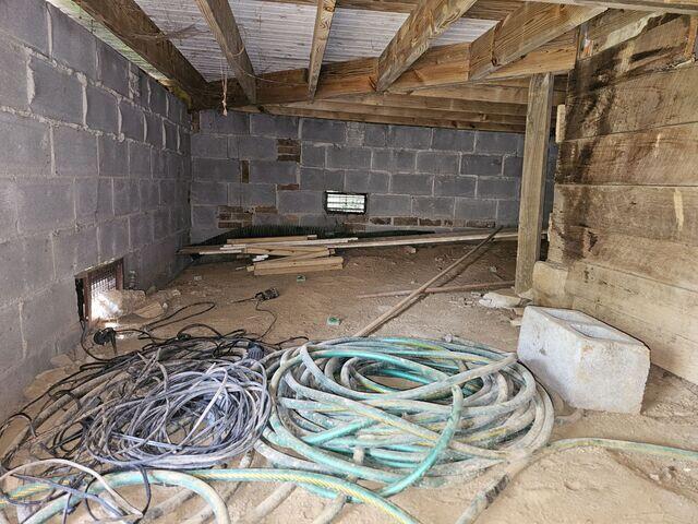 A crawlspace with a sandy terrain