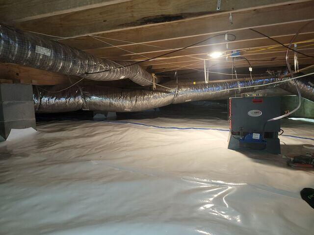 Crawlspace encapsulated with a dehumidifier.