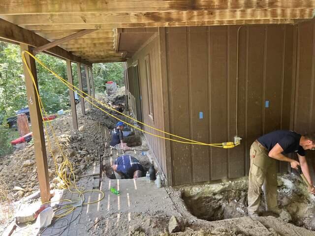 Our team working hard to install piers for this home in Kansas City.