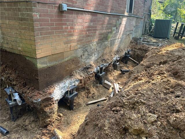 Helical piers have been installed beneath the foundation cement slab.