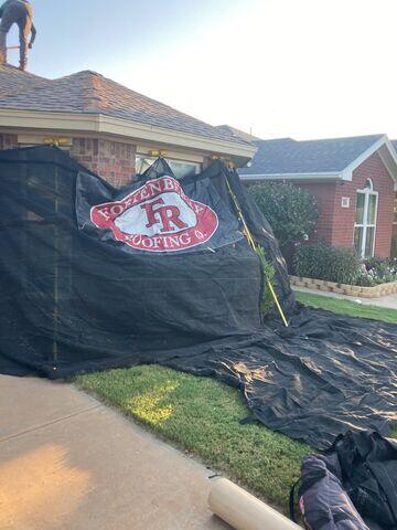 Tarping to protect the home.