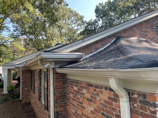 Side of home with broken gutter guards