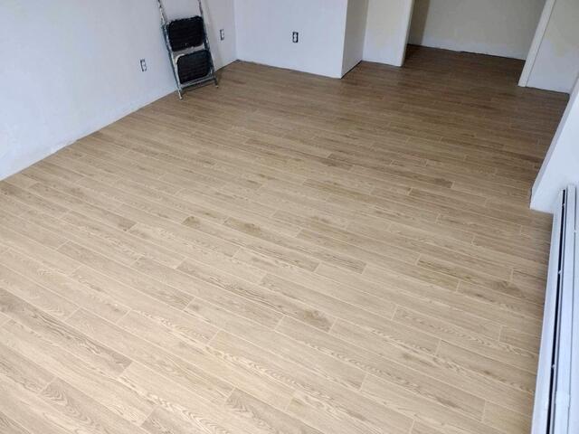 A basement bedroom finished with waterproof flooring by Matt Clark's Northern Basement Systems.