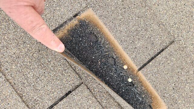 Shingles with improper nailing.