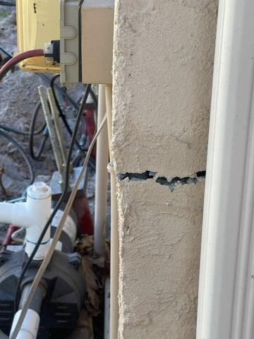 Large Cracks in Stucco Wall