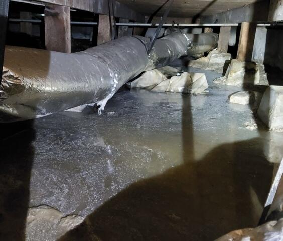 Standing water puddles sit stagnant in Pebble Beach, CA, crawlspace