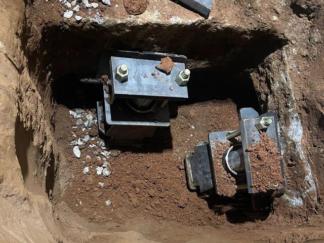 A close-up of the Push Piers installed inside a crawl space.