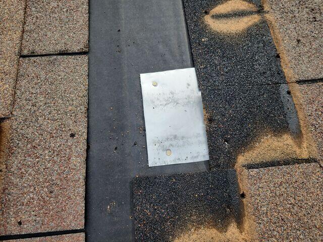 Removing all shingles around the hole.