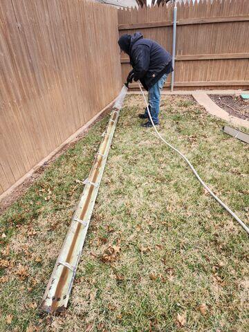 Technician Jesse cleaning and flushing out debris