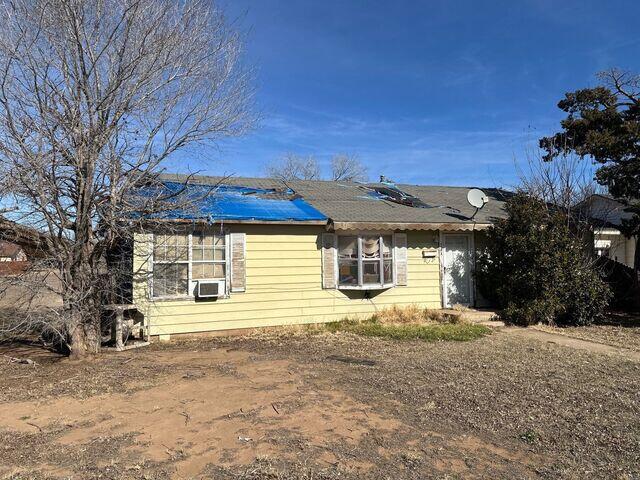 Front of house with more damage