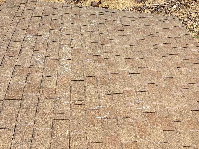Sales man marking off hail damage