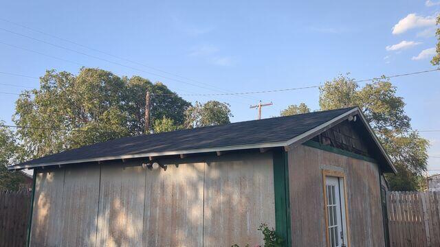 New and improved shingles on shed.